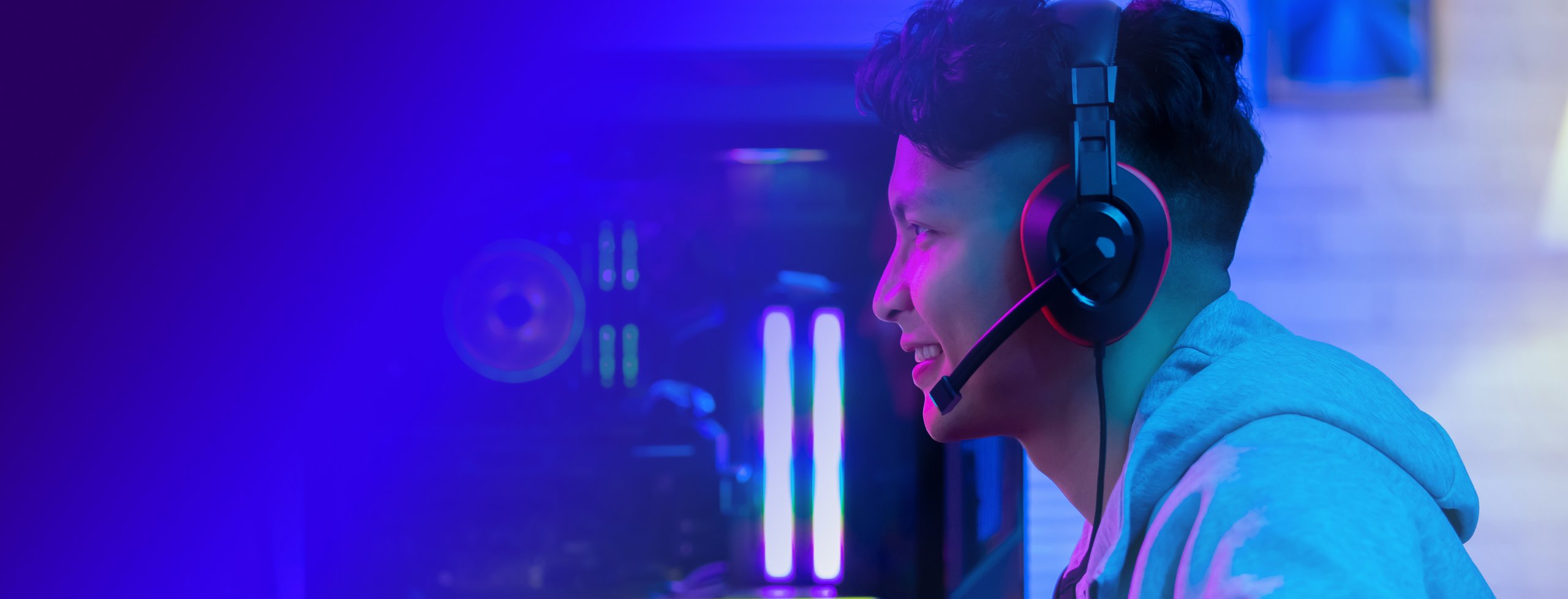 a young man wearing a headset while playing video games 